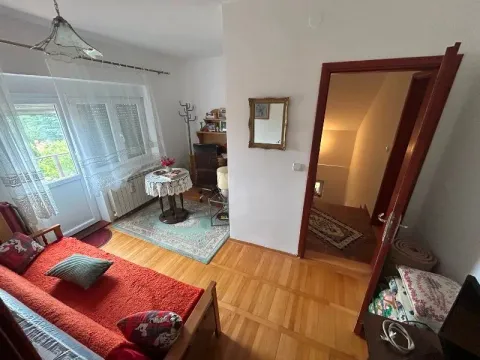 Small bedroom with a bed, desk, and access to the terrace. - image 12