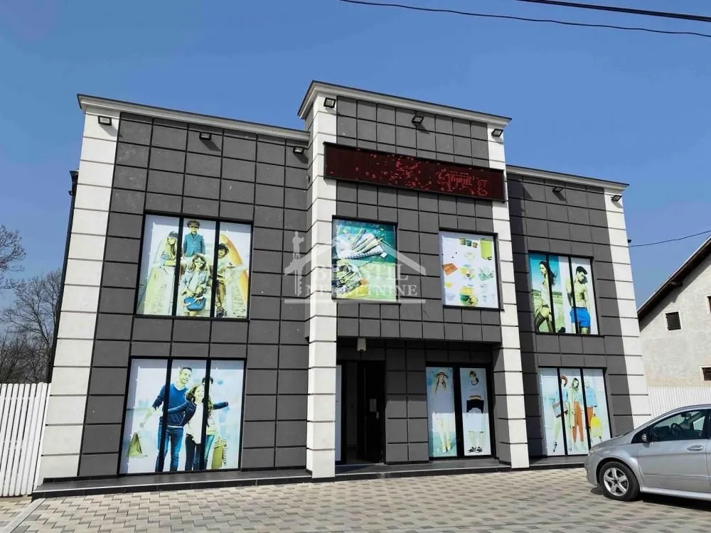 Front view of a commercial building with a modern facade and large display windows.