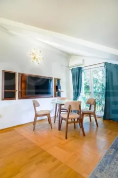 Living room with a dining table and chairs. - image 2