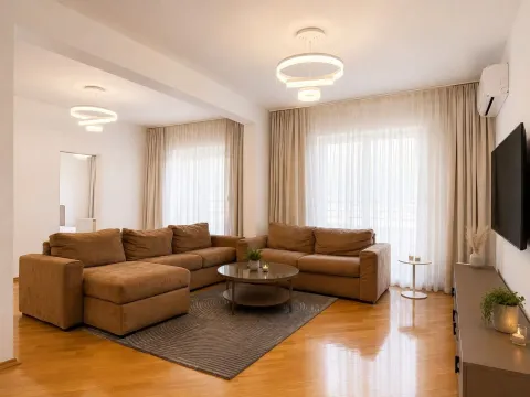Furnished and bright living room with a sofa set and a TV. - image 4