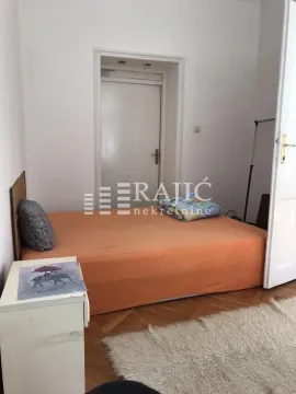 Smaller bedroom with a bed and parquet flooring. - image 6