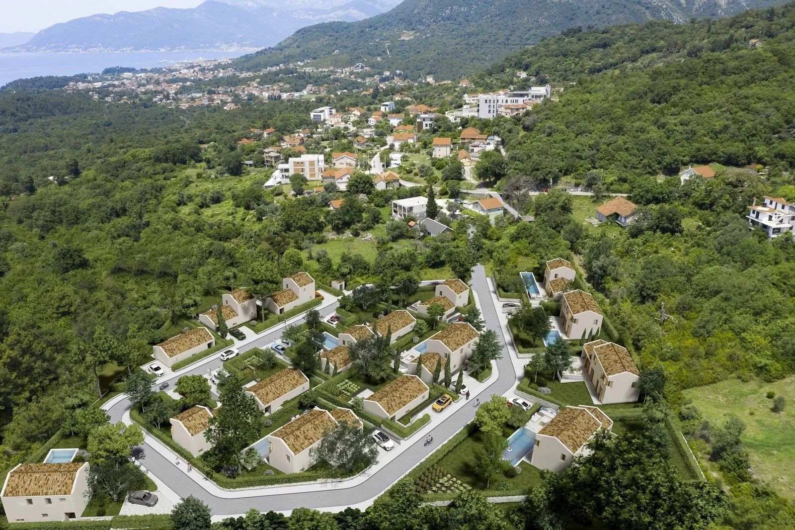 Pogled iz vazduha na kompleks kuća sa bazenima i zelenilom u prizemlju.