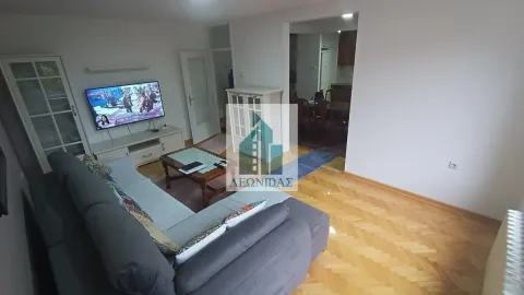 Living room with sofa, TV and view of the dining area. - image 6
