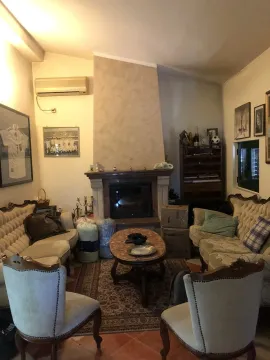 A living room featuring a fireplace, classic-style furniture, and a coffee table. - image 14