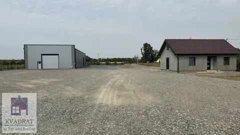 View of the yard with buildings and gravel ground. - image 4