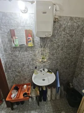 Smaller bathroom with a washbasin and a water heater on the wall. - image 8