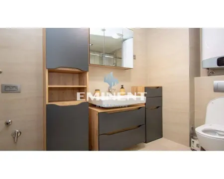 Modern bathroom equipped with a washbasin, cabinet, mirror, and toilet. - image 6