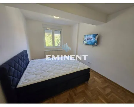 Bedroom with a double bed and a wall-mounted TV. - image 6