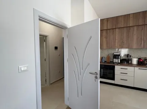 Moderna kuhinja sa bijelim elementima i drvenim gornjim ormarićima. - image 10