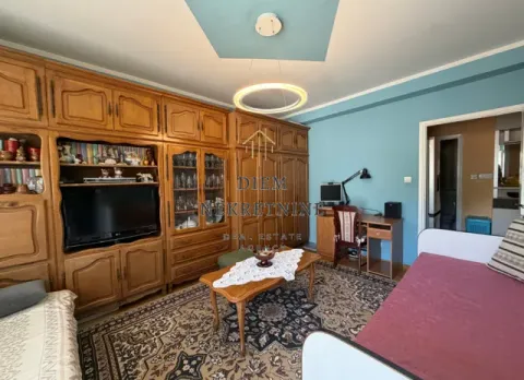Living room with wooden furniture, a sofa and a desk. - image 2