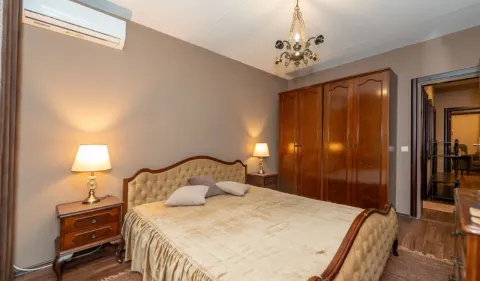 Furnished bedroom with a double bed, wooden wardrobe, and bedside tables. - image 7