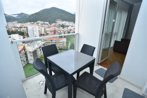 Furnished terrace with a table and chairs and a view of the city and hills. - image 14