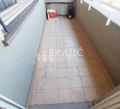 Small enclosed balcony with tiled flooring. - image 13
