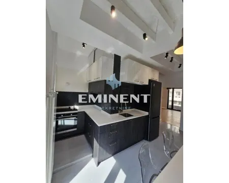 Modern kitchen with dark cabinetry and white countertops. - image 4