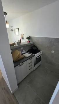 Small kitchen with cabinets and a stove. - image 4