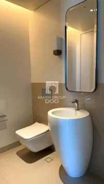 Modernly equipped bathroom with a washbasin and toilet. - image 7