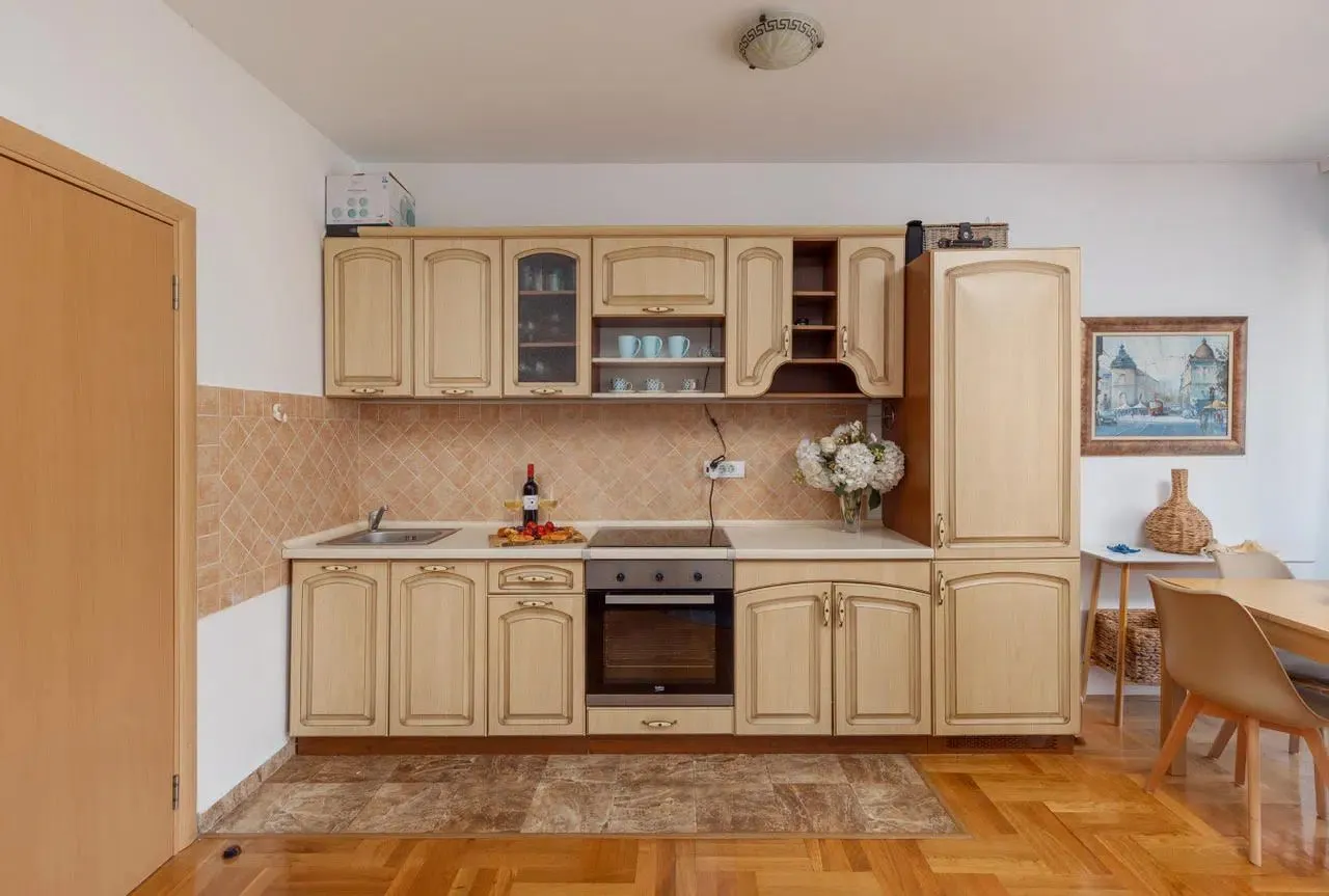 Kitchen with wooden cabinetry and a dining area.