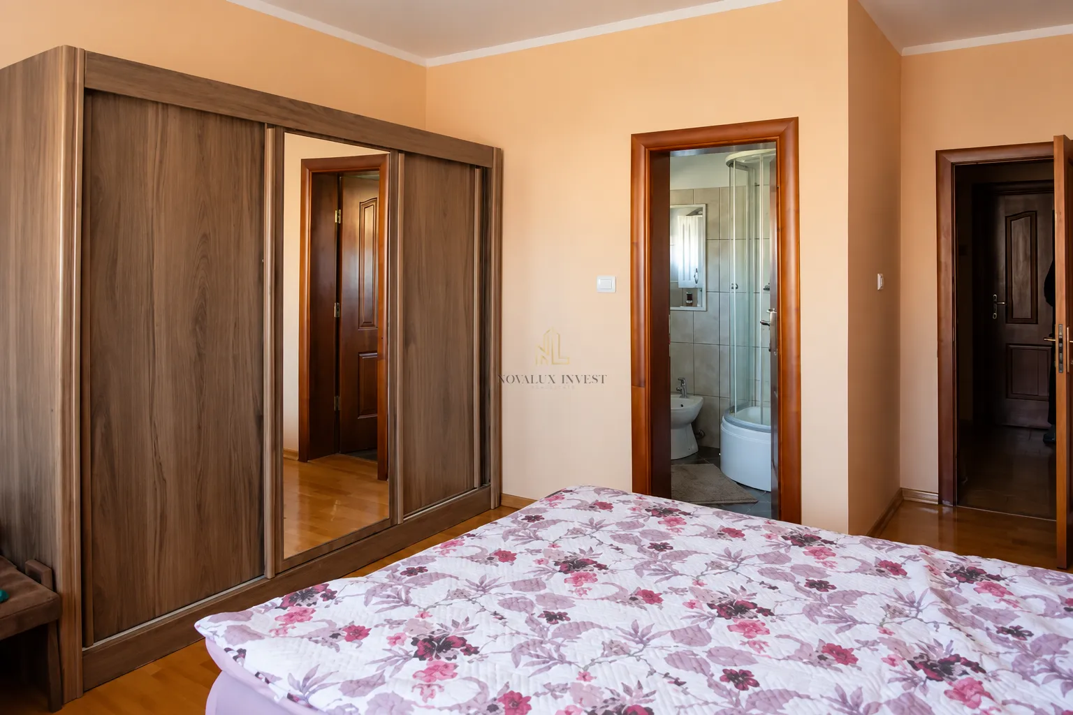 Bedroom with a large wardrobe and a double bed.