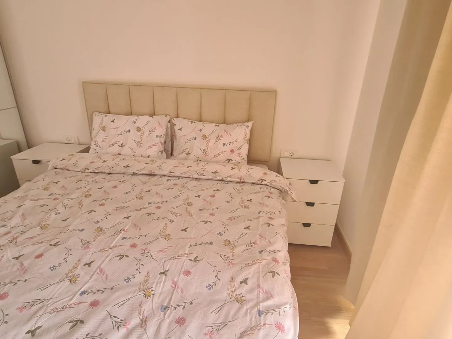 Furnished bedroom with a double bed and bedside tables.