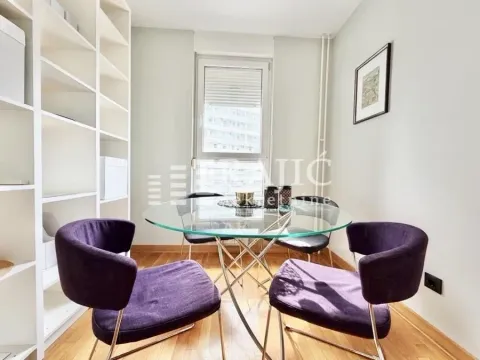 Dining room with a glass table and purple chairs. - image 4