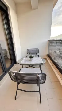 Furnished balcony with a table and two chairs. - image 11