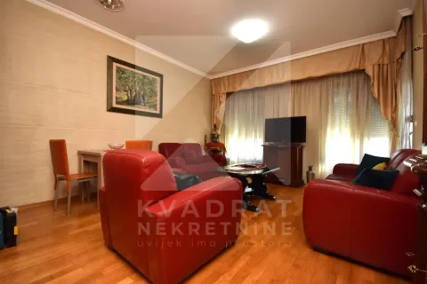 Living room with red leather sofas and a dining table. - image 2