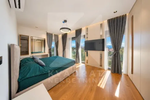 Modern bedroom with a double bed, TV, and access to the terrace. - image 6