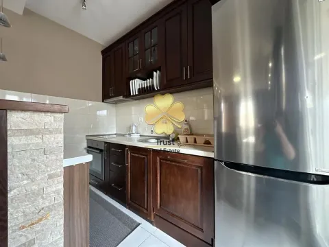 Smaller kitchen with dark wooden cabinets and a stainless steel refrigerator. - image 4
