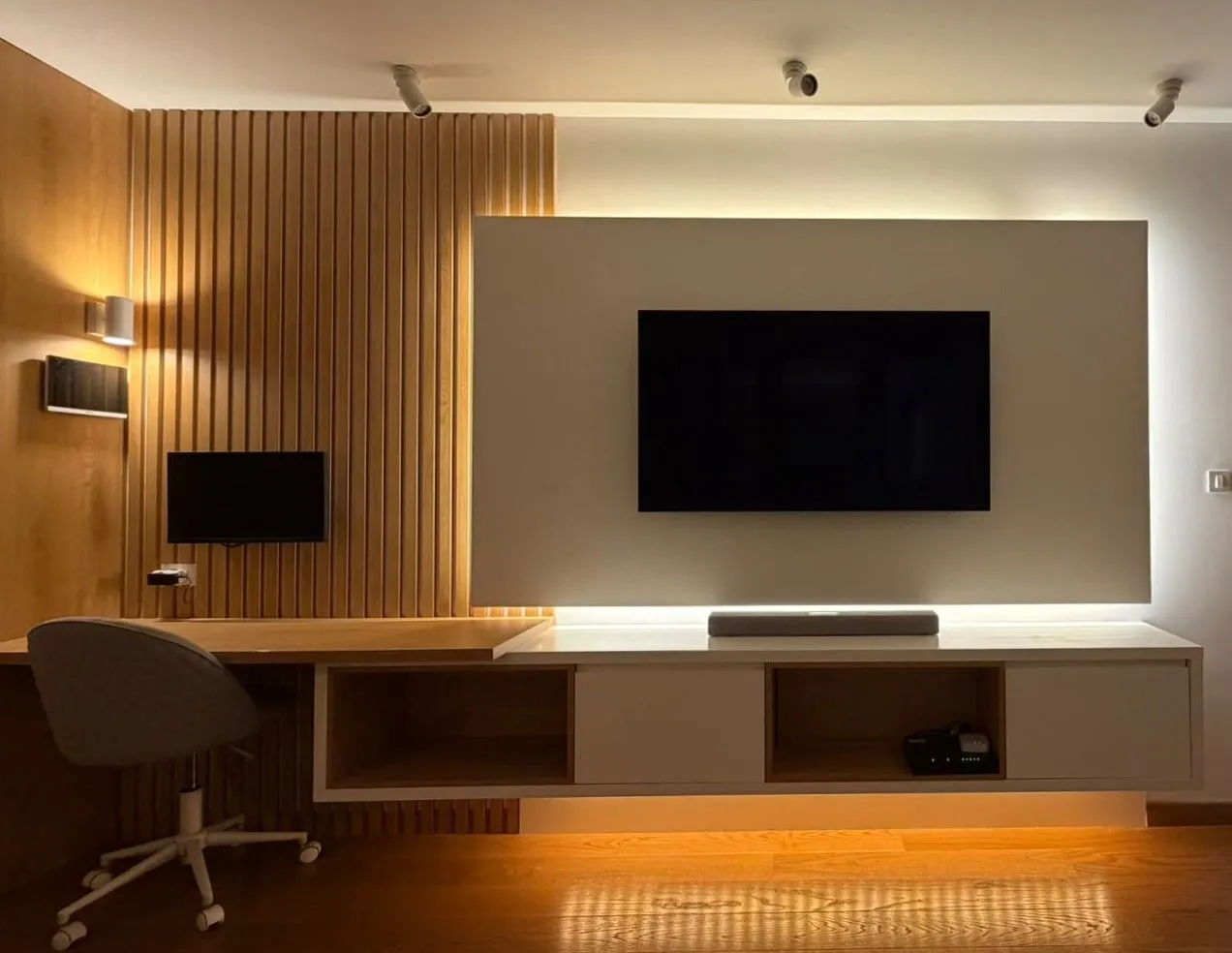 Modern living room with a TV unit and a desk.