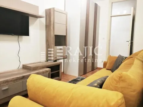 Living room with sofa, TV unit, and wardrobes. - image 9