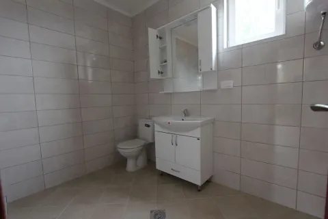 Bright bathroom with white fixtures and ceramic tiles. - image 4
