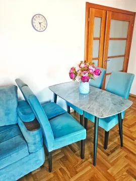 Living room with a sofa and dining table. - image 8