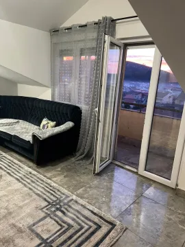 Dnevna soba sa garniturom i izlazom na terasu sa koje se pruža pogled. - image 3