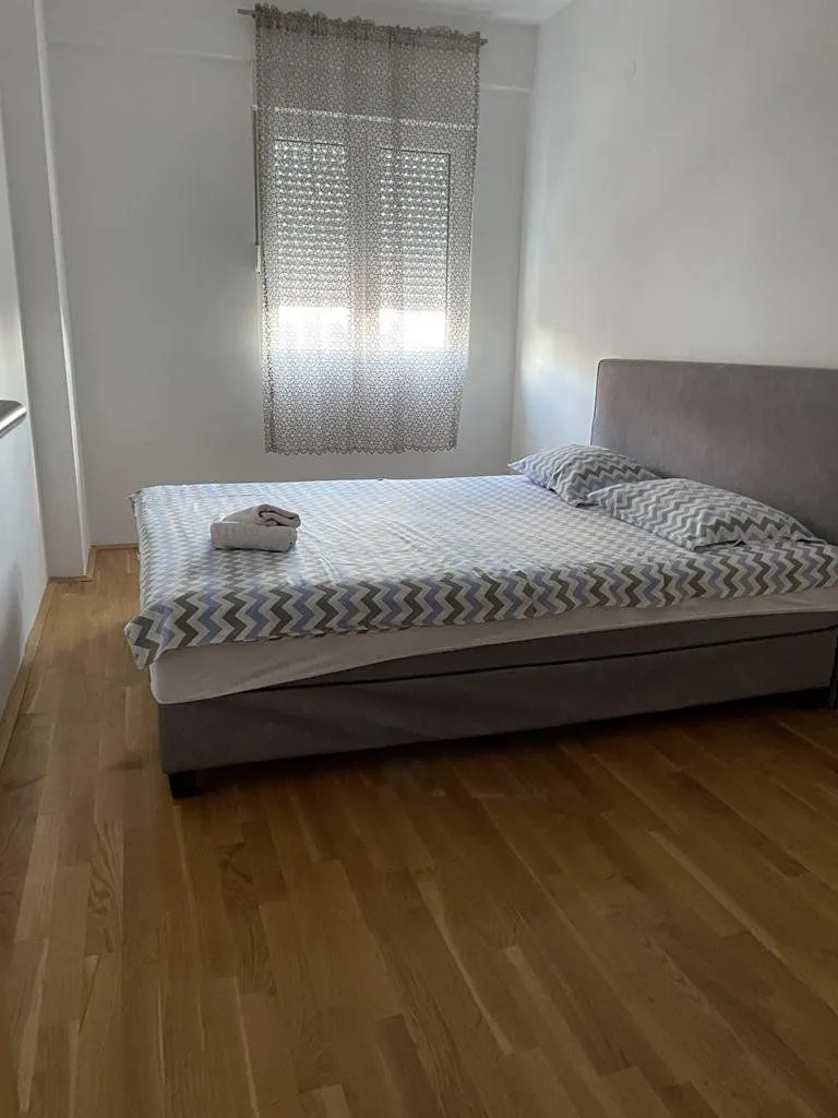 Bedroom with a double bed and wooden flooring.