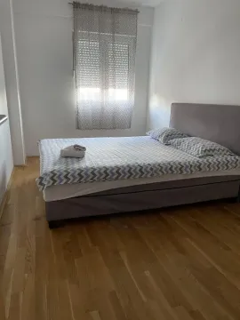 Bedroom with a double bed and wooden flooring. - image 6