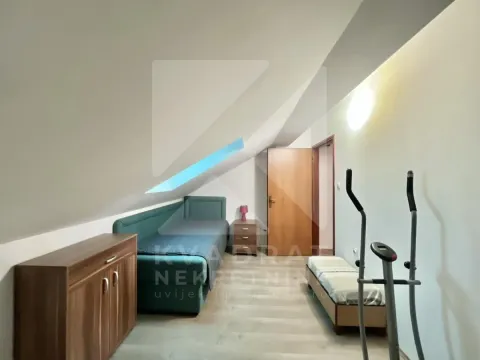 Attic room with a bed, dresser, and skylight. - image 8