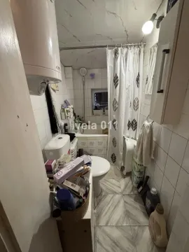 Small bathroom with a bathtub, toilet, and sanitary fixtures. - image 12
