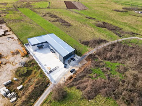 Aerial view of a modern industrial facility with an associated yard and surrounding land. - image 6
