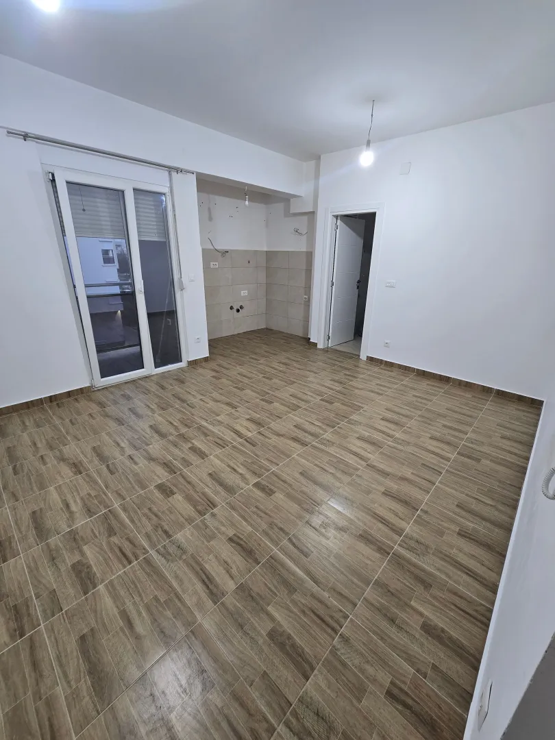 Empty unfinished room with tiled flooring and access to a terrace.