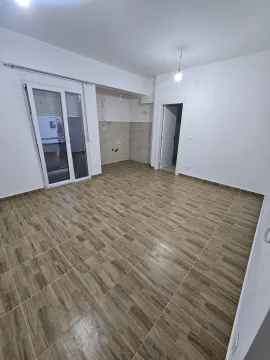 Empty unfinished room with tiled flooring and access to a terrace. - image 2