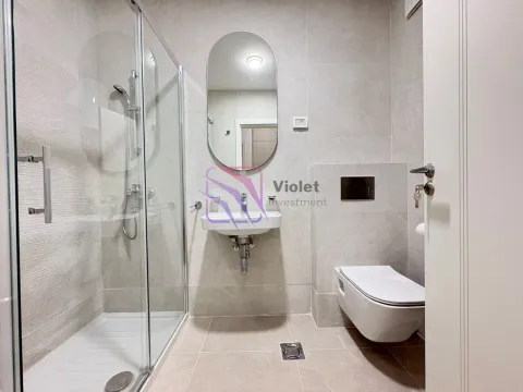 Modernly equipped bathroom with a shower cabin, washbasin, and toilet. - image 8