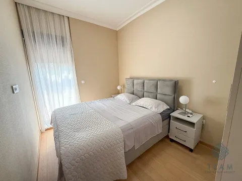 Furnished bedroom with a double bed and a bedside table. - image 8