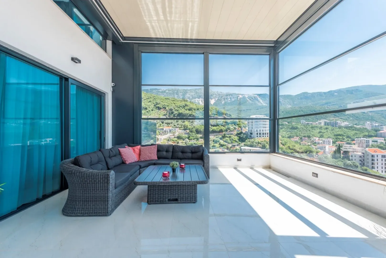 Glazed terrace featuring comfortable seating and panoramic mountain views.