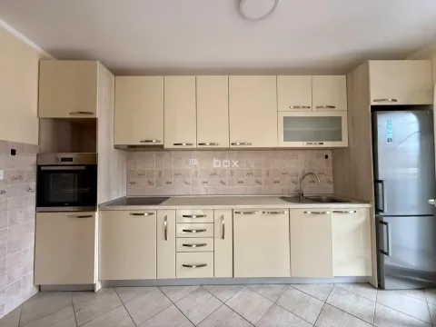 Equipped kitchen with light-colored cabinetry and built-in home appliances. - image 7