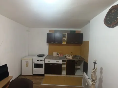 Smaller kitchen with cabinetry, stove, and refrigerator. - image 2