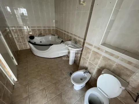 Bathroom equipped with a corner bathtub, washbasin, bidet, and toilet. - image 14