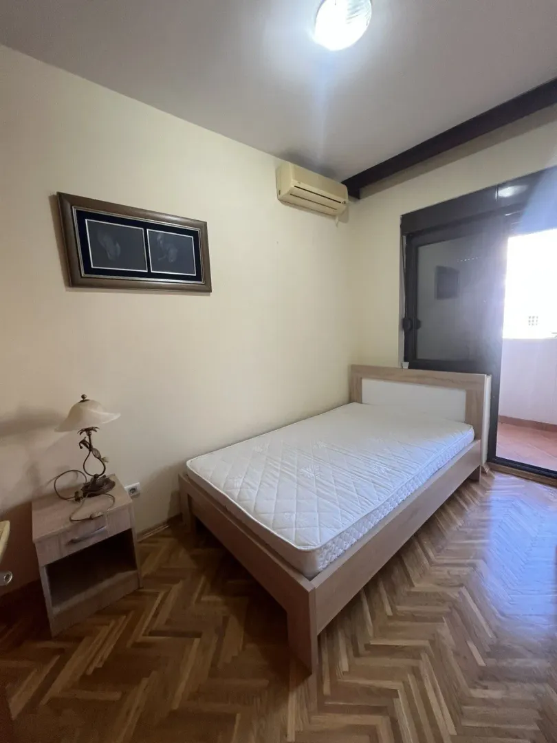 A simple bedroom with a single bed.