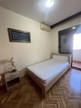 A simple bedroom with a single bed. - image 24
