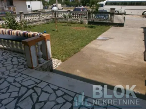 Yard with a lawn, concrete driveway, and fence. - image 2