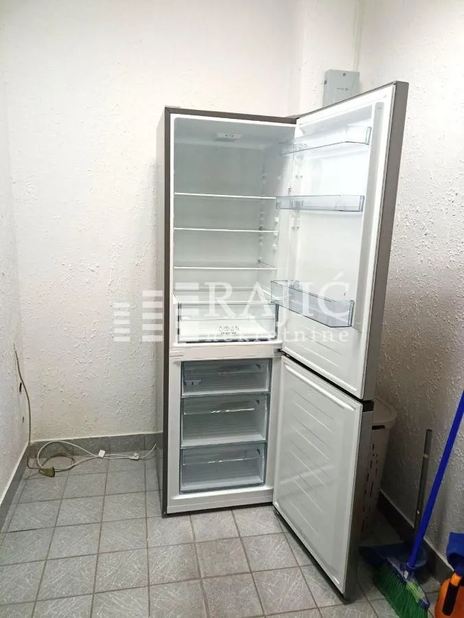 Refrigerator in the kitchen with the door open.